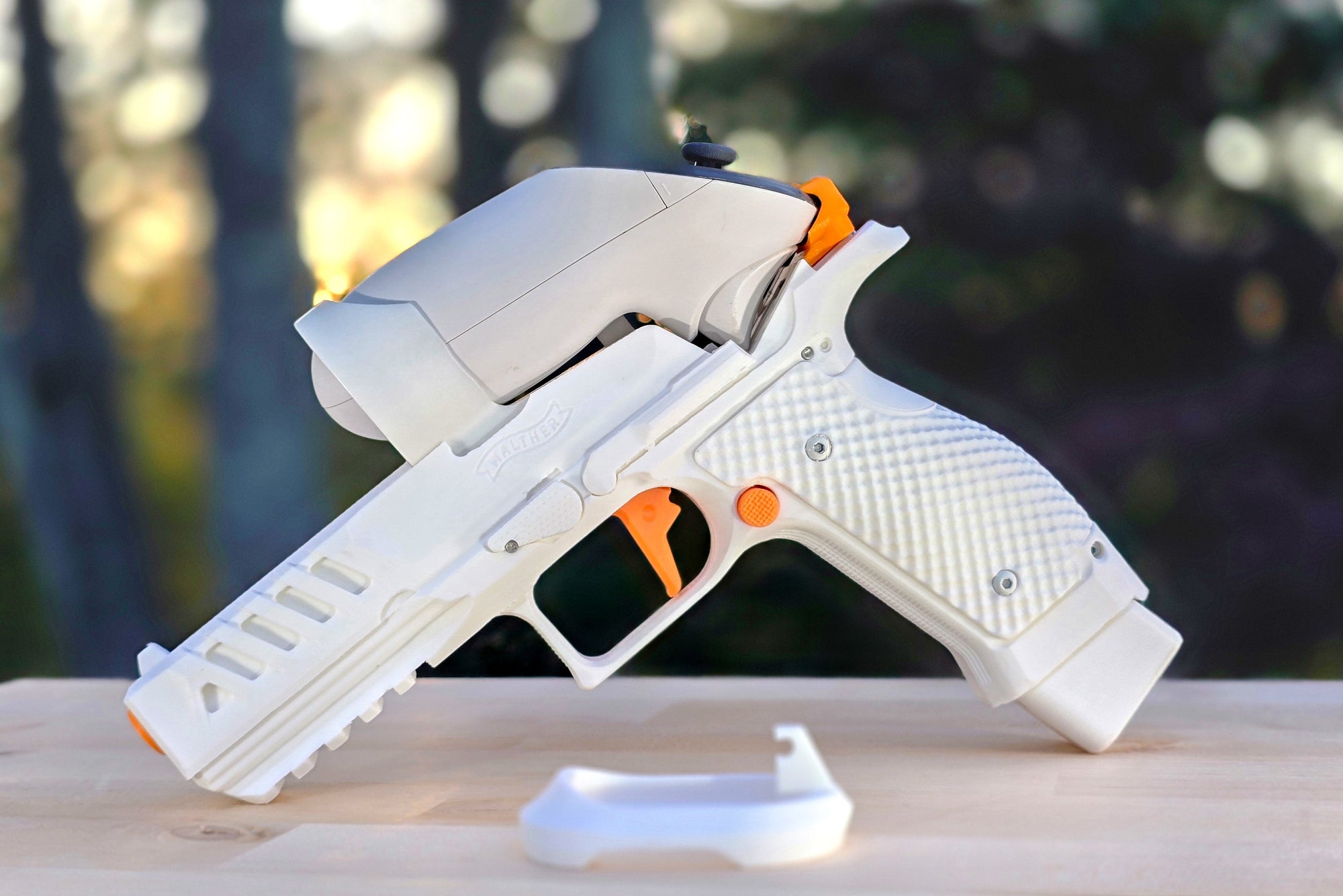 White toy gun with orange accents on a wooden surface